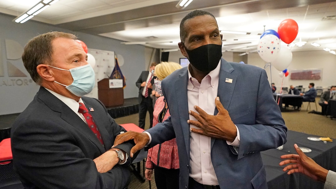 Utah Gov. Gary Herbert, left, speaks with Burgess Owens, Republican candidate in Utah's 4th Congressional District, during an Utah Republican election night party Tuesday, Nov. 3, 2020, in Sandy, Utah. (AP Photo/Rick Bowmer)