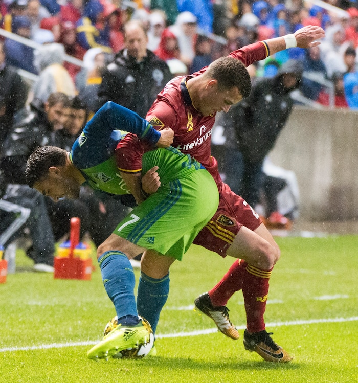 (Rick Egan  |  The Salt Lake Tribune)  Real Salt Lake forward Brooks Lennon (27) gets tangled up with Seattle Sounders midfielder Cristian Roldan (7), as he goes for the ball, in MLS soccer action, Real Salt Lake vs Seattle Sounders, in Sandy, Utah, Saturday, September 23, 2017.