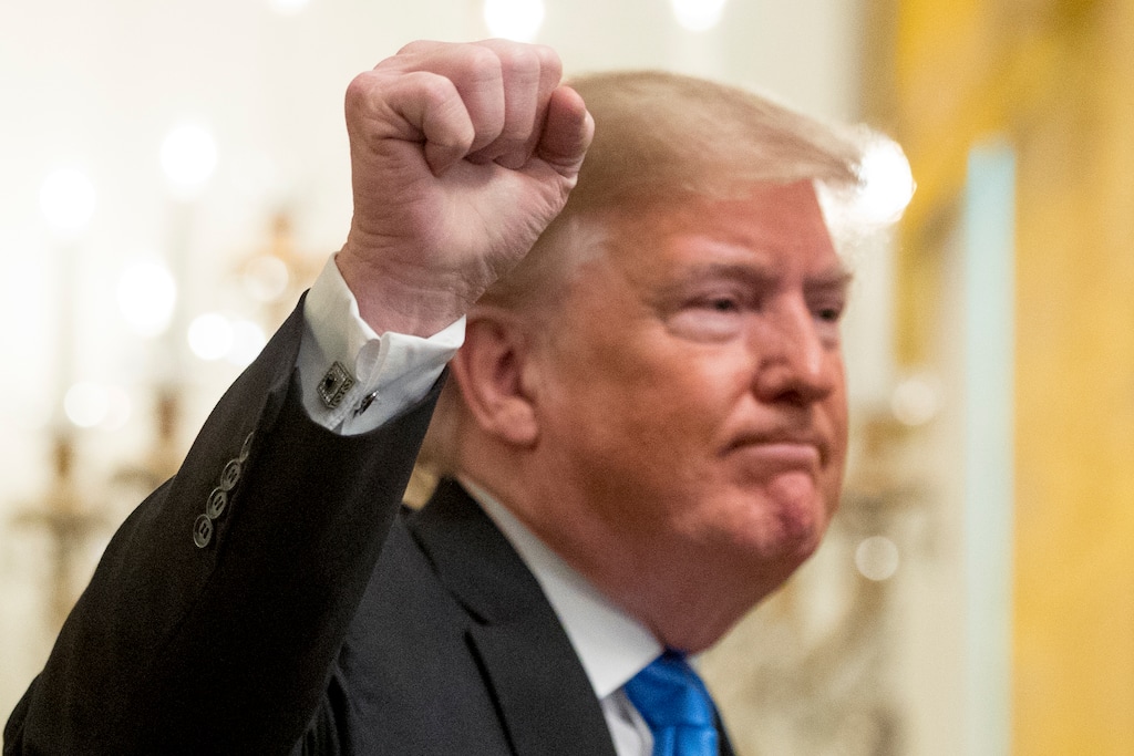 President Donald Trump holds up a fist after speaking at the 2018 Young Black Leadership Summit in the East Room of the White House, Friday, Oct. 26, 2018, in Washington. (AP Photo/Andrew Harnik)