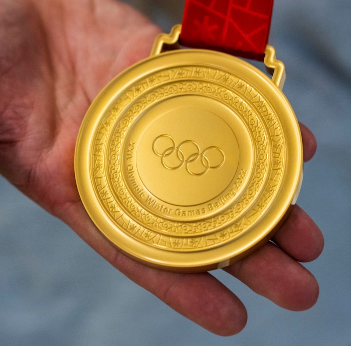 (Rick Egan | The Salt Lake Tribune) Kaillie Humphries displays the gold medal she won in the women's monobob, as she and other Team USA Olympians arrive at the Salt Lake City International Airport on Monday, Feb. 21, 2022.