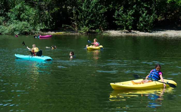 (Rick Egan  |  The Salt Lake Tribune)    Kids swim and paddle kayaks, as they float on Farmington Pond, Thursday, July 26, 2018.