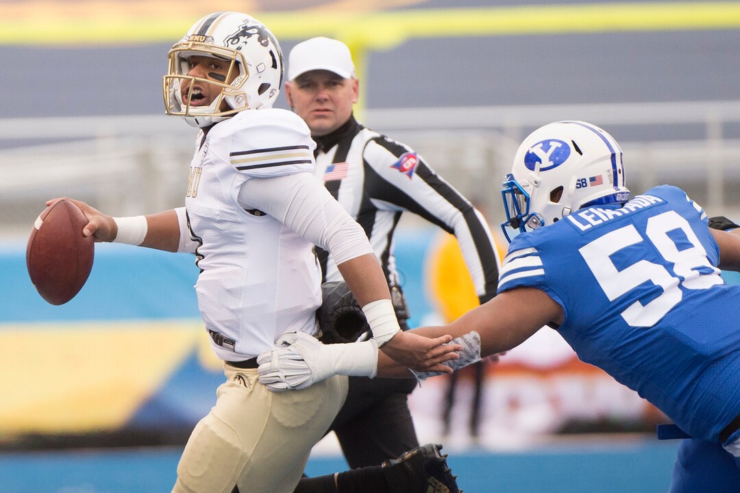 (Jeremy Harmon  |  The Salt Lake Tribune) Western Michigan Broncos quarterback Kaleb Eleby (9) is chased by Brigham Young Cougars defensive lineman Uriah Leiataua (58) as BYU faces the Western Michigan Broncos in the Famous Idaho Potato Bowl in Boise, Idaho, on Friday, Dec. 21, 2018.