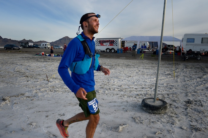(Scott Sommerdorf | The Salt Lake Tribune)
Alex Doolan smiles as he crosses the finish line at the Salt Flats 100 Endurance Run, Saturday, May 5, 2018. Doolan finished in 8th place.

