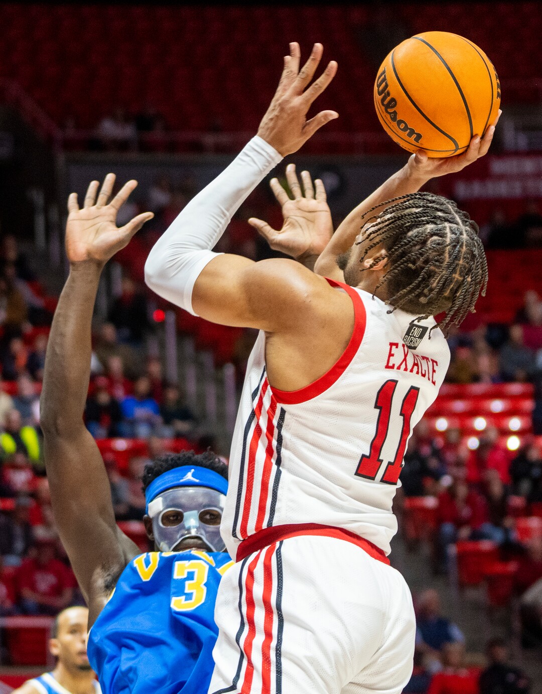 (Rick Egan | The Salt Lake Tribune) Utah Utes guard Wilguens Exacte Jr. (11) shoots over UCLA Bruins forward Adem Bona (3), in PAC-12 basketball action between Utah Utes and UCLA Bruins, at the Jon M. Huntsman Center, Thursday, February. 23, 2022.