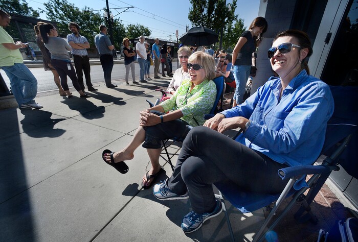 (Scott Sommerdorf | The Salt Lake Tribune) Kristi Swan, right, was the first in line at 7am, as hundreds of hopeful eclipse-watchers line up outside the Clark Planetarium in hopes of getting eclipse glasses from the gift shop, Thursday, August 17, 2017. Alongside Swan as the earliest arrivals are, Frances Davis, center, and Karen Wildfoerster, behind Davis.