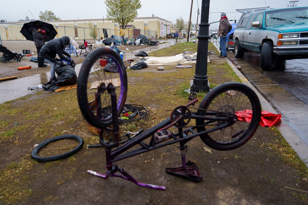 (Trent Nelson  |  The Salt Lake Tribune) People sort their belongings as Salt Lake County conducts a camp cleanup at the Fleet Block Murals in Salt Lake City on Wednesday, April 14, 2021.