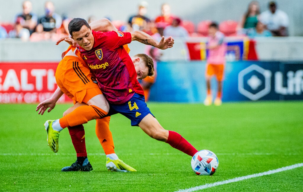 (Isaac Hale | Special to The Tribune) Real Salt Lake defender Donny Toia (4) gets tangled up with Houston Dynamo forward Tyler Pasher (19), but keeps possession of the ball during a MLS game between Real Salt Lake and Houston Dynamo FC at Rio Tinto Stadium in Sandy on Saturday, June 26, 2021.