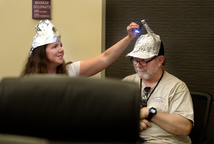 (Scott Sommerdorf | The Salt Lake Tribune)
Utah Republican Party Central Committee members Dana Goff, left, helped George Edwards with the light atop his tinfoil hat during a 90 minute debate over what form of voting should be used at the beginning of the Utah Republican Party Central Committee meeting, Saturday, September 9, 2017. Members were split between electronic voting, and old fashioned paper ballots. Voting using paper ballots won out after a demonstration of the electronic voting system failed.