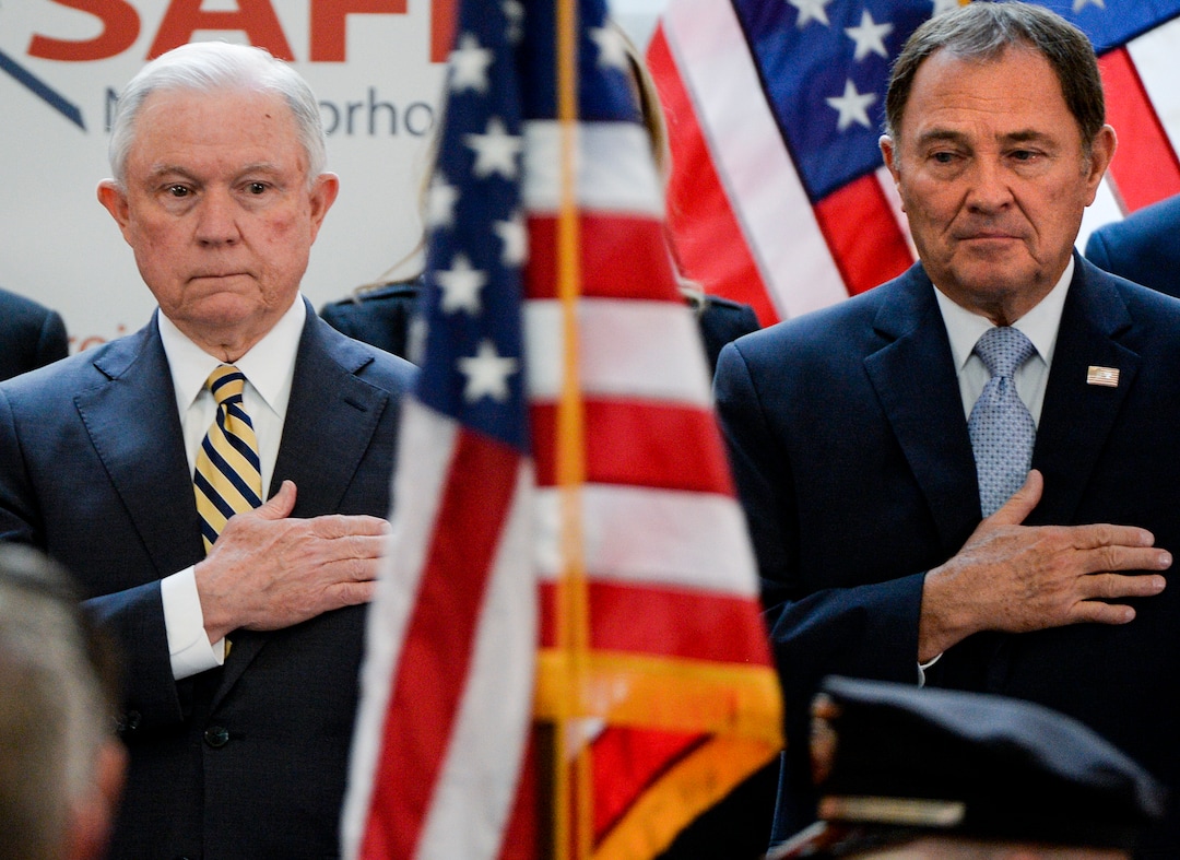 Leah Hogsten  |  The Salt Lake Tribune   l-r U.S. Attorney General Jeff Sessions and Governor Gary Herbert watch as the Ogden City Police Honor Guard presents the flag in the rotunda. Sessions touted Project Safe Neighborhoods, Wednesday, October 3, 2018, at the Utah Capitol, on the one year anniversary since the Trump administration returned to the policy pushed by the George W. Bush administration. Under Project Safe Neighborhoods, federal prosecutors focus on security stiff sentences for those convicted of gun crimes and reducing violent crimes.