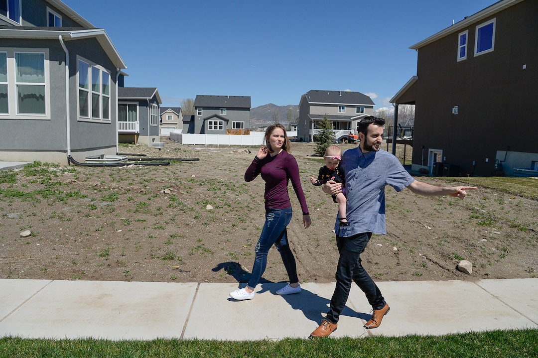 (Francisco Kjolseth  |  The Salt Lake Tribune)  Ember and Jeremy Ulrich take their daughter Jemma, 1, for a walk around their newly developed neighborhood in Lehi after moving there from Pleasant Grove last October. Along with some friends who were also looking to get more house for their money and ended up moving in next door, Jeremy wanted to be closer to his job at Adobe in Lehi.