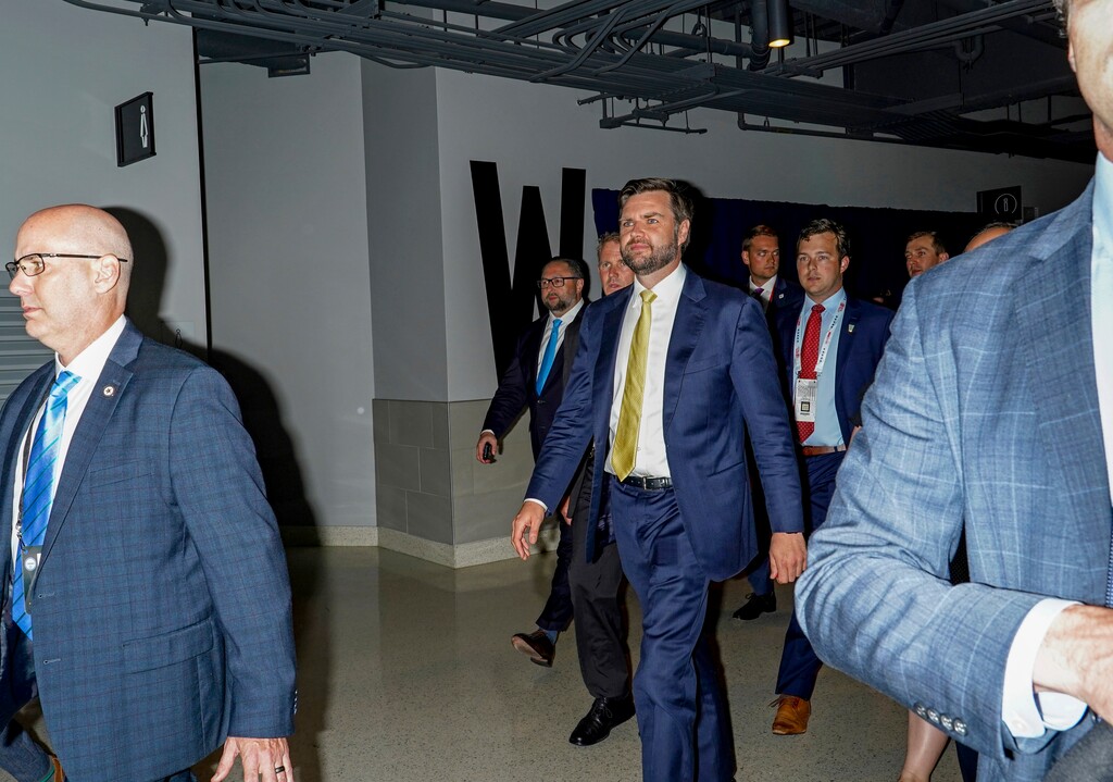 Sen. JD Vance (R-Ohio), the Republican vice presidential nominee, center, walks through a walkway at the Republican National Convention at the Fiserv Forum in Milwaukee, on July 16, 2024. “JD Vance once feared that Donald Trump might become “America’s Hitler.” Now he’s Trump’s running mate. But never mind that history. Trump and Vance have a lot of things, including this, in common: They’re both con men who despise their most avid supporters,” writes The New York Times columnist Paul Krugman. (Jamie Lee Taete/The New York Times)