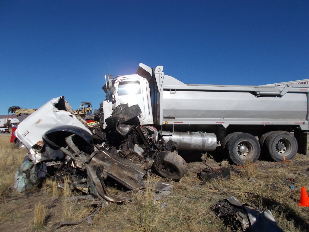 (Courtesy Utah Highway Patrol) A dump truck is stopped atop the mangled remains of a pickup truck it collided into Friday, Oct. 19, on State Route 40, near the Jordanelle Reservoir. Six people were killed in the crash, which troopers believe was caused by impaired driving.