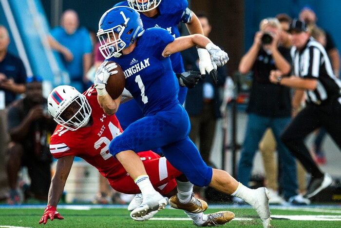 (Chris Detrick  |  The Salt Lake Tribune)  Bingham's Braedon Wissler (1) runs past East's Jaylon Vickers (24) during the game at Bingham High School Friday, August 25, 2017. Bingham is winning the game 24-17 at halftime. 