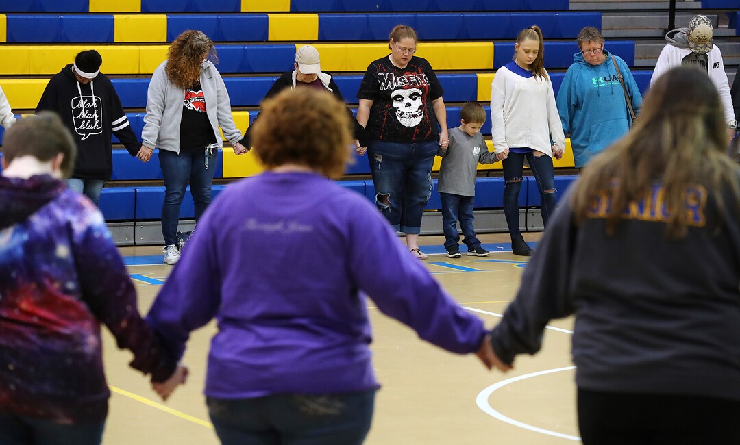 Students, teachers and local residents hold a prayer circle in the gymnasium of Beauregard High School for those in their community that lost their lives in a Sunday night tornado on Monday, March 4, 2019, in Beauregard, Ala. (Curtis Compton//Atlanta Journal-Constitution via AP)