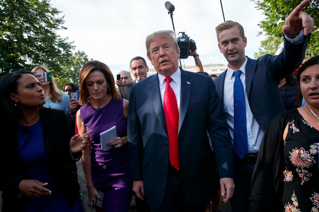 President Donald Trump walks to an interview on the North Lawn of the White House, Friday, June 15, 2018, in Washington. (AP Photo/Evan Vucci)