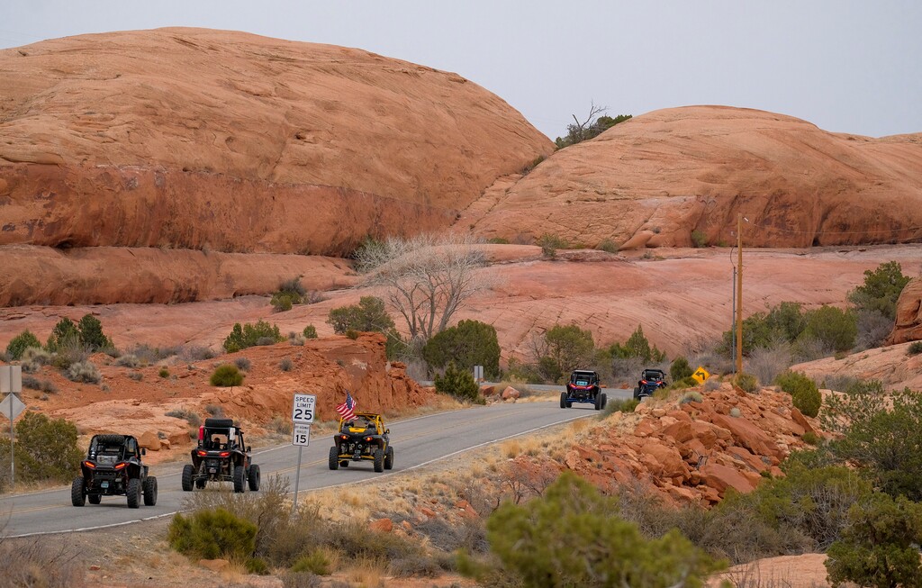(Leah Hogsten | The Salt Lake Tribune) Several off-road utility terrain vehicles (UTVs) motor towards the Fins & Things 4x4 Trail at the Sand Flats Recreation Area trail, located just 4 miles from downtown Moab, Feb. 19, 2021. 