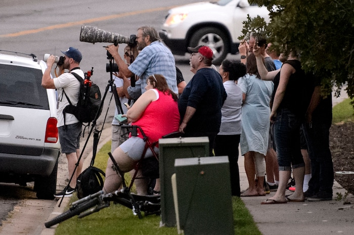 (Steve Griffin  |  The Salt Lake Tribune)  People gather at a vantage point where the can see aircraft dropping retardant on a fire burning on a ridgeline above homes in Bountiful Tuesday August 29, 2017.
