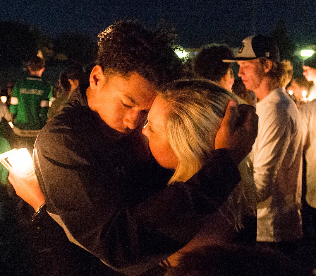 (Rick Egan  |  The Salt Lake Tribune)Heidi Paxman hugs Bishop Brown, at a candlelight vigil in honor of coach Cazzie Brown, at Hillcrest High School, Monday, August 28, 2017.