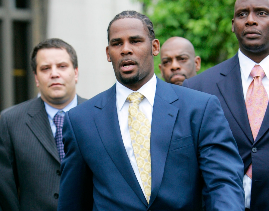 (AP Photo/Nam Y. Huh, File) In this June 13, 2008 file photo, R&B singer R. Kelly leaves the Cook County Criminal Court Building in Chicago after a jury found him not guilty on all counts in his child pornography trial. In 2002, Kelly was indicted on 21 counts of child pornography, based on a videotape allegedly showing him having sex with an underage girl.