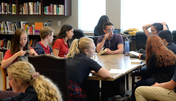 (Francisco Kjolseth  |  The Salt Lake Tribune)  Dean of Students, Dustin Simmons goes over reading assignments with students in the school library at the Lindon charter school Karl G. Maeser Preparatory Academy on Tuesday, May 8, 2018. The academy was named Utah's best high school by U.S. News and World Report.
