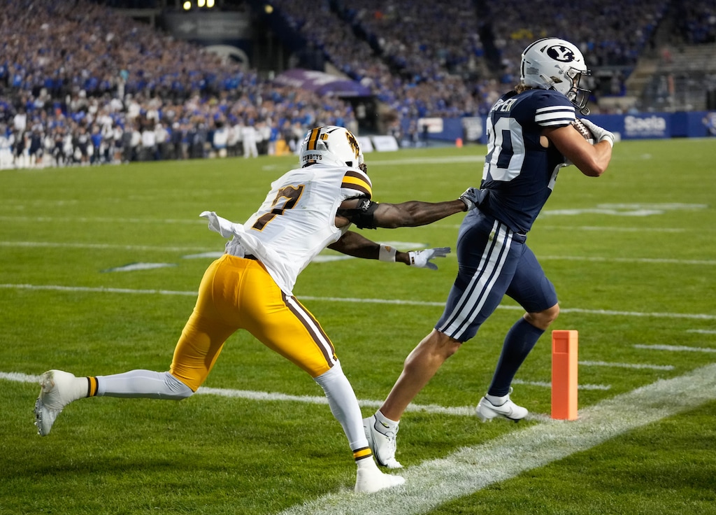 (Francisco Kjolseth | The Salt Lake Tribune) Brigham Young Cougars wide receiver Brayden Cosper (20) manages to stay in the green for a touchdown ahead of Cowboys cornerback Jakorey Hawkins (7) in the final seconds of the first half in football action between the Brigham Young Cougars and the Wyoming Cowboys at LaVell Edwards Stadium in Provo, on Saturday, Sept. 24, 2022.