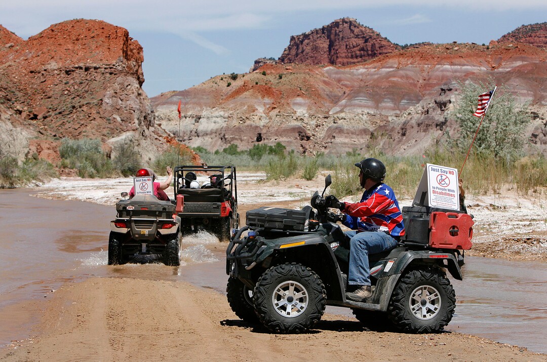 (Scott Sommerdorf  |  Tribune File Photo)  ATV riders pass deeper into the national monument along the Paria riverbed. ATV and off-road vehicle riders numbering about 100 protested BLM road closures in Grand Staircase-Escalante National Monument on Saturday.