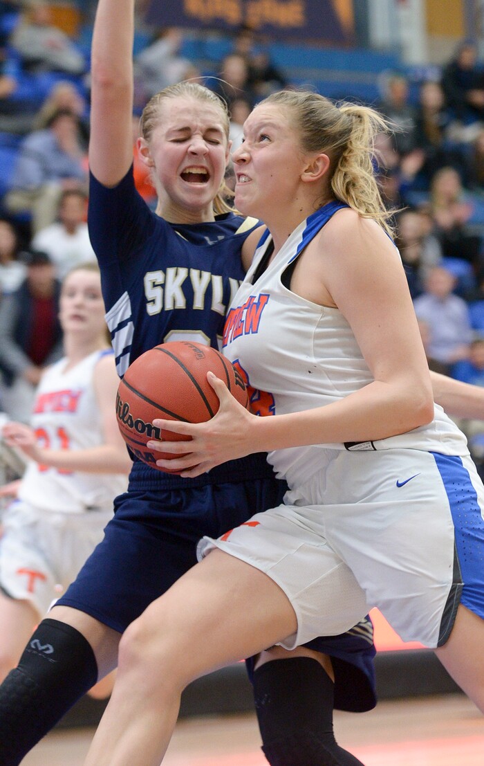 (Leah Hogsten  |  The Salt Lake Tribune) Timpview's Ella Pope (04) tries to drive around Skyline's Madison Grange (25).  Timpview faces Skyline in their semifinal game of the 5A High School Girls' Basketball Tournament at SLCC in Taylorsville, Friday, Feb. 23, 2018. 