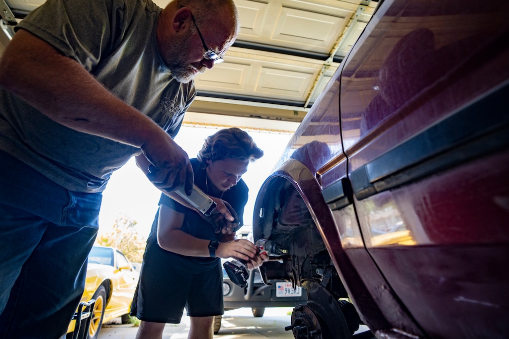(Rick Egan | The Salt Lake Tribune) Mike Johnson and Erik Dahlgreen work on a car in their garage in Kearns, on Tuesday, May 12, 2026.