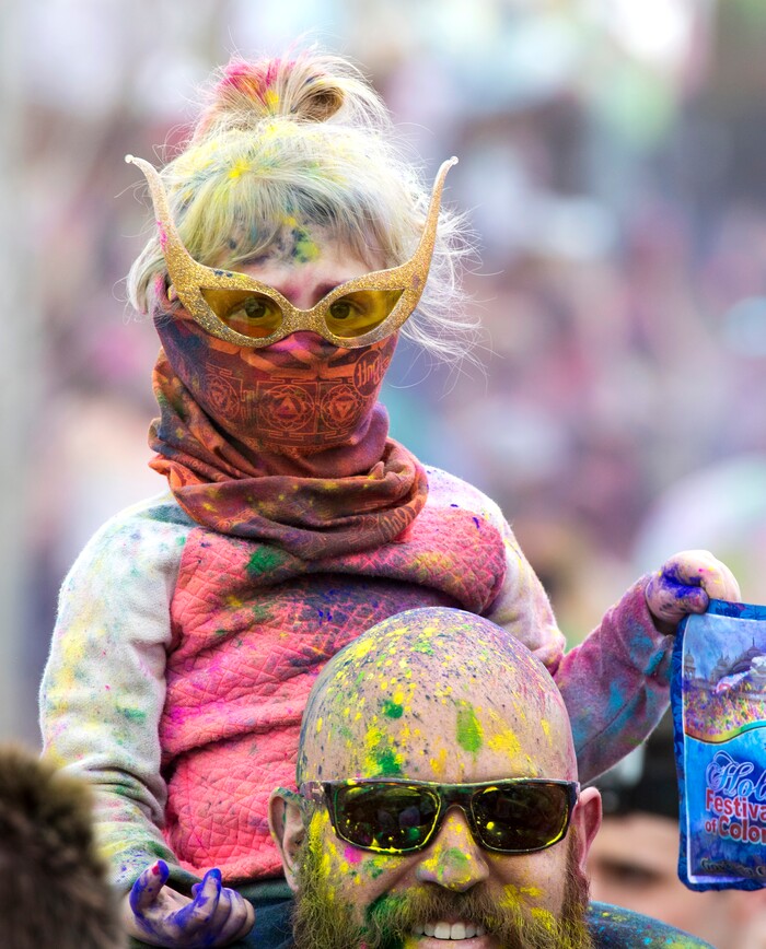(Rick Egan  |  The Salt Lake Tribune)      Arina Fox, 3, from Provo sits on her dad Tyler's shoulders, during the 22nd annual Holi Festival of Colors at the Sri Sri Radha Krishna Temple in Spanish Fork, Saturday, March 24, 2018. The festival which celebrates the beginning or spring is also known as at the Festival of Love.