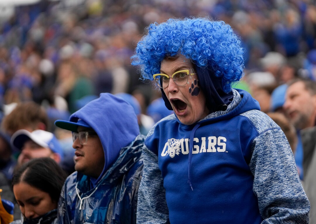 (Bethany Baker  |  The Salt Lake Tribune) A Brigham Young Cougars fan cheers during the game against the Oklahoma Sooners at LaVell Edwards Stadium in Provo on Saturday, Nov. 18, 2023.