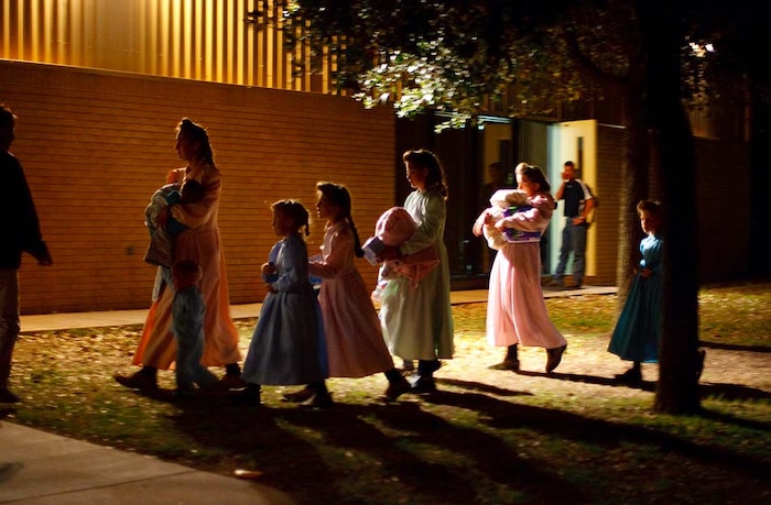 (Trent Nelson | The Salt Lake Tribune)
Eldorado, Texas - In April 2008, Child Protective Services (CPS) raided a polygamous sect's Texas ranch and removed 416 children after receiving phone calls, now believed to be a hoax, from someone claiming to be an abused sixteen-year-old girl. This raid on the FLDS Church's YFZ (Yearning for Zion) Ranch became the largest child custody case in United States history. Here, on the first night of removals, young FLDS women and children are taken into shelter at the First Baptist Church in Eldorado, Texas.