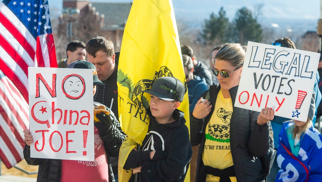 (Rick Egan | The Salt Lake Tribune). A small crowd of Trump protesters gather at the capitol with signs, flags and guns on Wednesday, Jan. 6, 2021.
