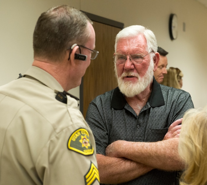     (Rick Egan  |  The Salt Lake Tribune)        Utah County sheriff's Sgt. Spencer Cannon talks to Bill Powell, Riley’s father, after Jerrod Baum appeared for a hearing in Provo. Baum is accused of killing 18-year-old Riley Powell and 17-year-old Brelynne “Breezy” Otteson in December and dumping their bodies into an abandoned mine shaft. Thursday, April 26, 2018.   

