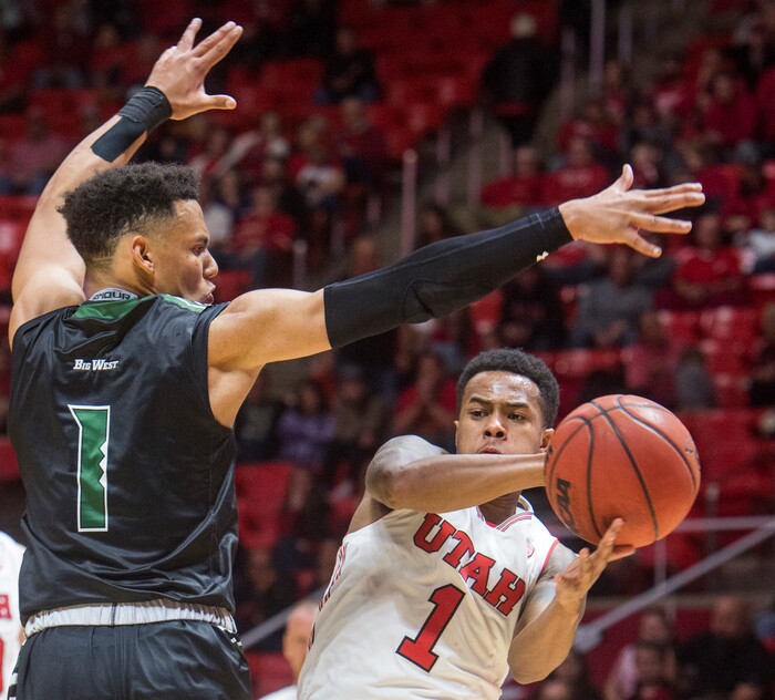 (Rick Egan  |  The Salt Lake Tribune)  Utah Utes guard Justin Bibbins (1) tosses a pass around Hawaii Warriors guard Drew Buggs (1), in basketball action, Utah Utes vs Hawaii Warriors, at the Jon M. Huntsman Center, Saturday, December 2, 2017.