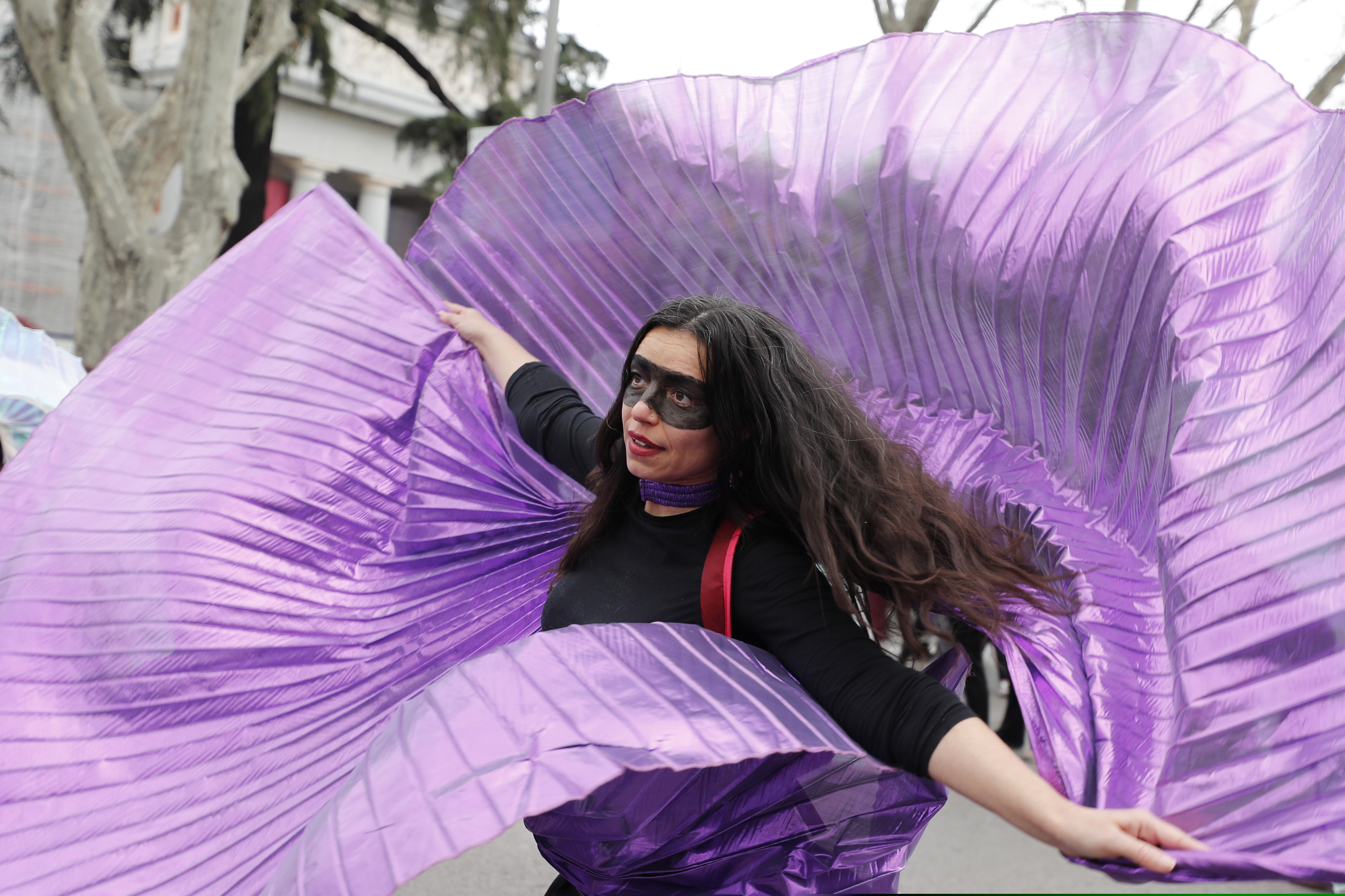 A protester dances during a march on International Women's Day in Madrid, Spain, Sunday, March 8, 2020, Thousands of women are marching in Madrid and other Spanish cities as part of International Women's Day. (AP Photo/Paul White)