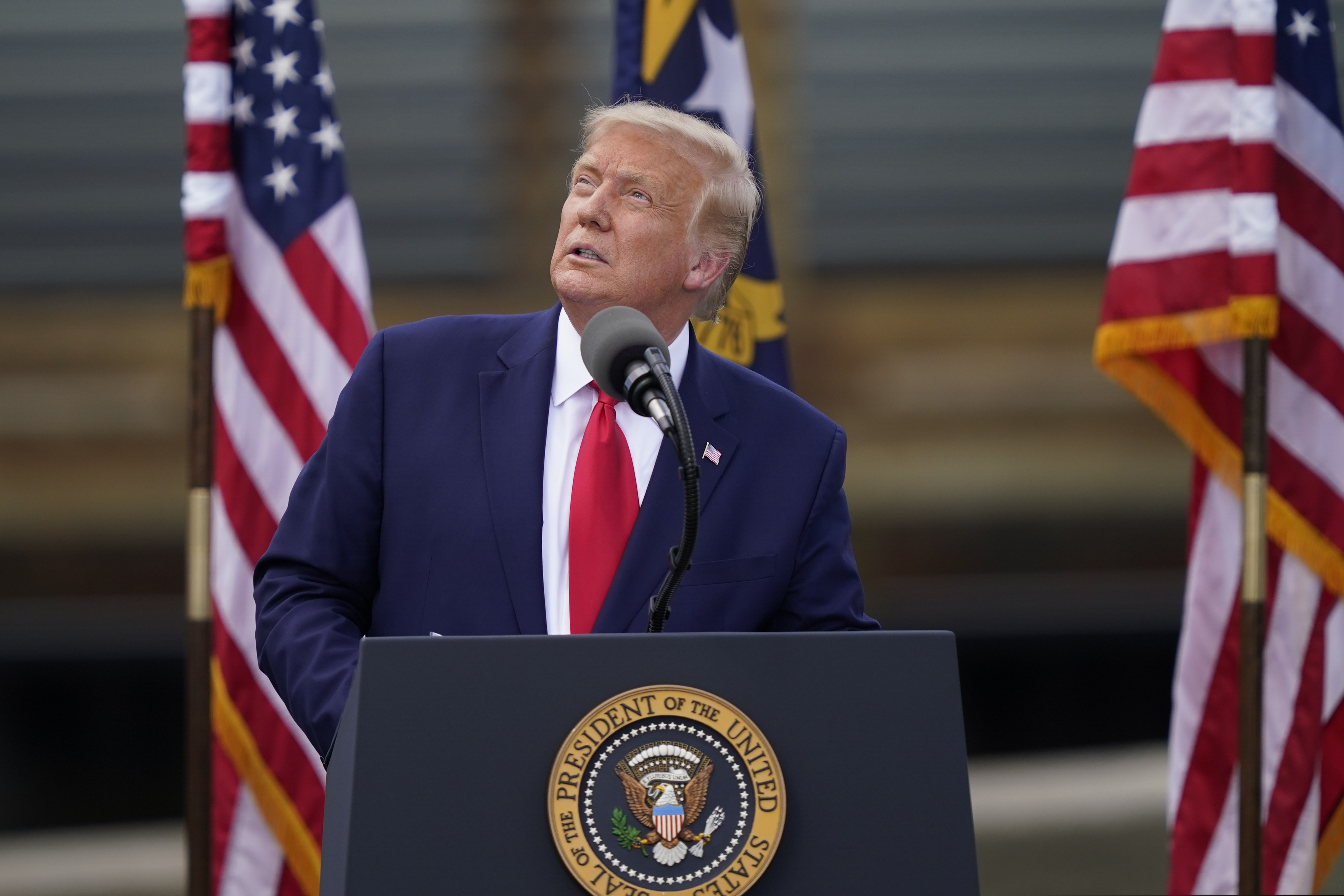 (Gerry Broome | AP) With the USS Battleship North Carolina in the background, President Donald Trump speaks on Wednesday, Sept. 2, 2020, in Wilmington, N.C.