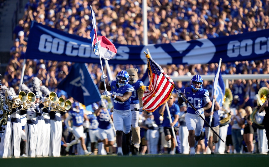 (Francisco Kjolseth | The Salt Lake Tribune) BYU players run onto the field for their NCAA college football game against Utah Tech, Saturday, Sept. 5, 2026, at LaVell Edwards Stadium in Provo.