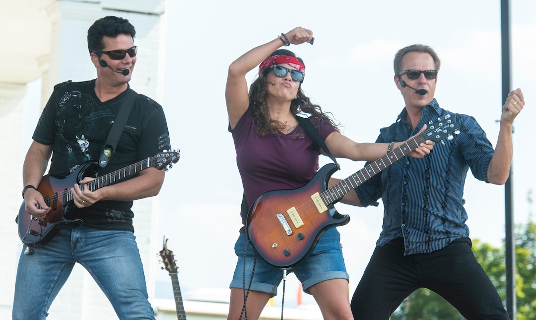 (Rick Egan  |  The Salt Lake Tribune)    Autumn Butler, from Ogden, (Center) is a rock star for a day, as she plays guitar with Pat Balder and Glen Everhart during the SongBlast Dueling Guitars show at the Utah State Fair Monday, Sept. 9, 2019.