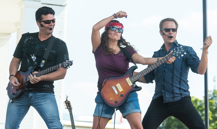 (Rick Egan  |  The Salt Lake Tribune)    
Autumn Butler, from Ogden, (Center) is a rock star for a day, as she plays guitar with Pat Balder and Glen Everhart during the SongBlast Dueling Guitars show at the Utah State Fair Monday, Sept. 9, 2019.