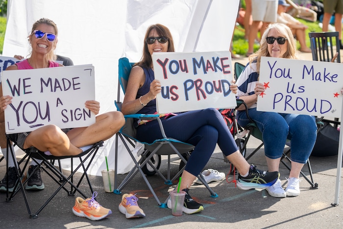 (Rick Egan | The Salt Lake Tribune) From left, Madison Warren, Karen Warren and Sue Lamb hold signs at the Days of '47 Parade in Salt Lake City on Thursday, July 24, 2025.