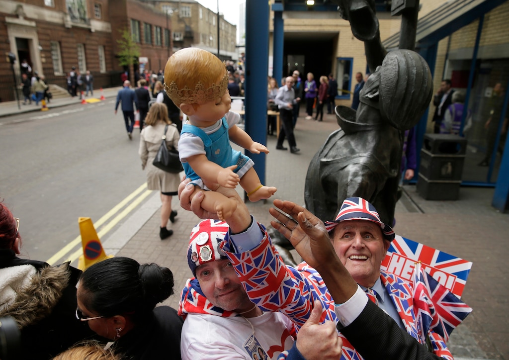 (Tim Ireland | The Associated Press) Royal fans John Loughrey and Terry Hutt, right, pose holding a baby doll opposite the Lindo wing at St Mary's Hospital in London, Monday, April 23, 2018. Kensington Palace says the Duchess of Cambridge has given birth to her third child, a boy weighing 8 pounds, 7 ounces.