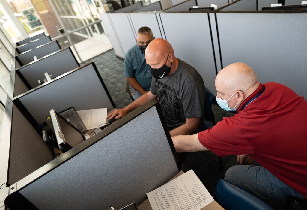 (Francisco Kjolseth | Tribune file photo) Richard Crippen, center, a veteran looking for work gets help with his resume from Robert Woefley, right, and Amado Gonzales at the Department of Workforce Services center in Clearfield on Friday, May, 14, 2021. Utah’s unemployment rate fell to 2.8% in April, less than half the U.S. rate of 6.1% for the month, according to the U.S. Bureau of Labor Statistics.