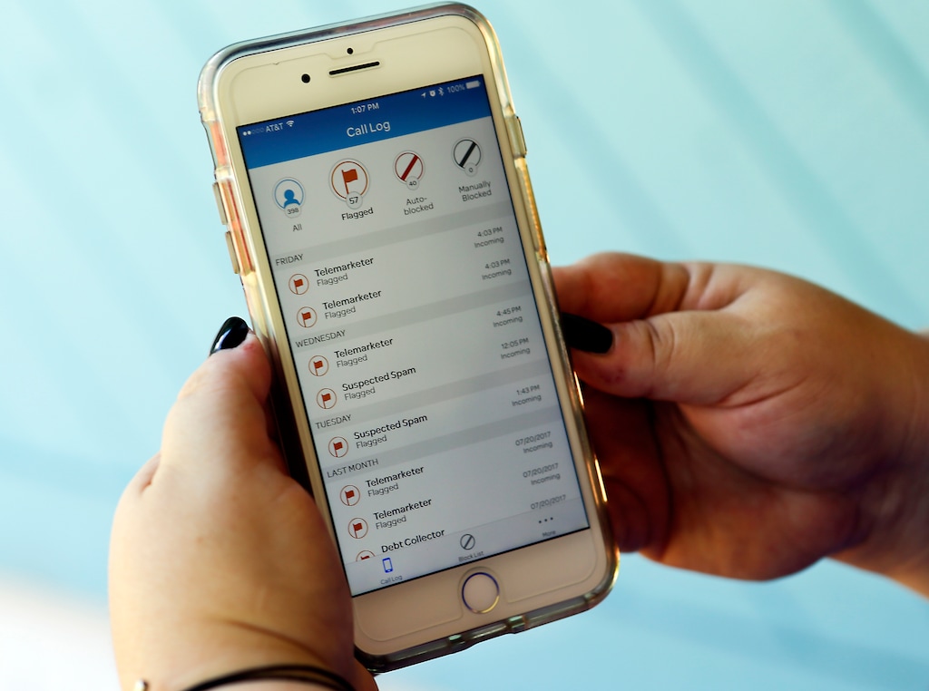 FILE - In this Tuesday, Aug. 1, 2017, file photo, Jen Vargas looks at a call log displayed via an AT&T app on her cellphone at her home in Orlando, Fla. The app helps locate and block fraudulent calls, although some robocalls still get through. On Thursday, Nov. 16, 2017, the Federal Communications Commission adopted new rules giving phone companies greater authority to block automated messages known as robocalls from reaching customers. (AP Photo/John Raoux, File)