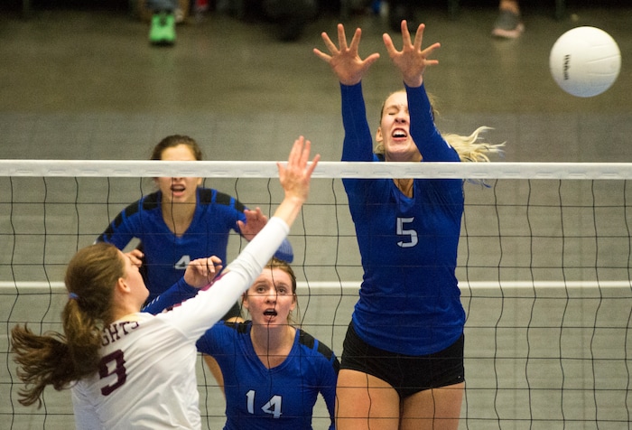 (Rick Egan  |  The Salt Lake Tribune)    Lone Pea Knights  Madelyn Robinson (9) hits the ball, as Pleasant Grove Vikings Heather Gneiting (5) defends, in 6A volleyball championship action, Pleasant Grove vs. Lone Peak, at Utah Valley University, Saturday, November 4, 2017.