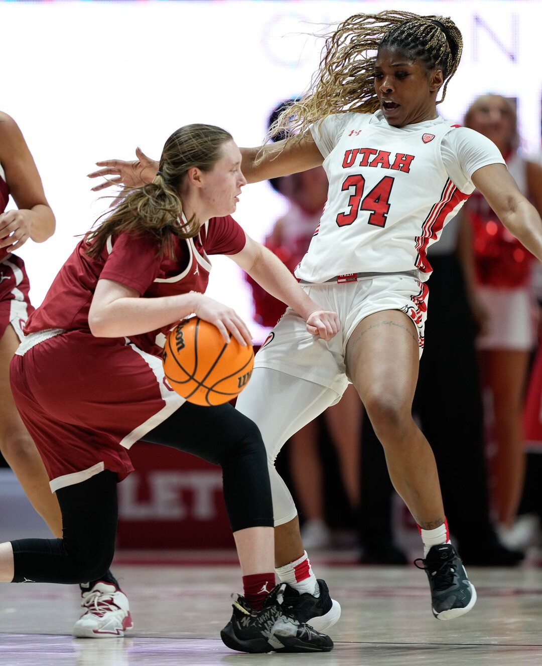 (Francisco Kjolseth | The Salt Lake Tribune) Oklahoma Sooners guard Taylor Robertson (30) pushes Utah Utes forward Dasia Young (34) as the University of Utah hosts the Oklahoma Sooners in women’s NCAA basketball in Salt Lake City on Wednesday, Nov. 16, 2022.