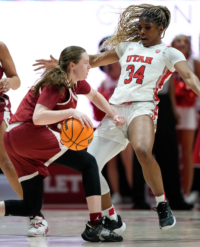 (Francisco Kjolseth | The Salt Lake Tribune) Oklahoma Sooners guard Taylor Robertson (30) pushes Utah Utes forward Dasia Young (34) as the University of Utah hosts the Oklahoma Sooners in women’s NCAA basketball in Salt Lake City on Wednesday, Nov. 16, 2022.