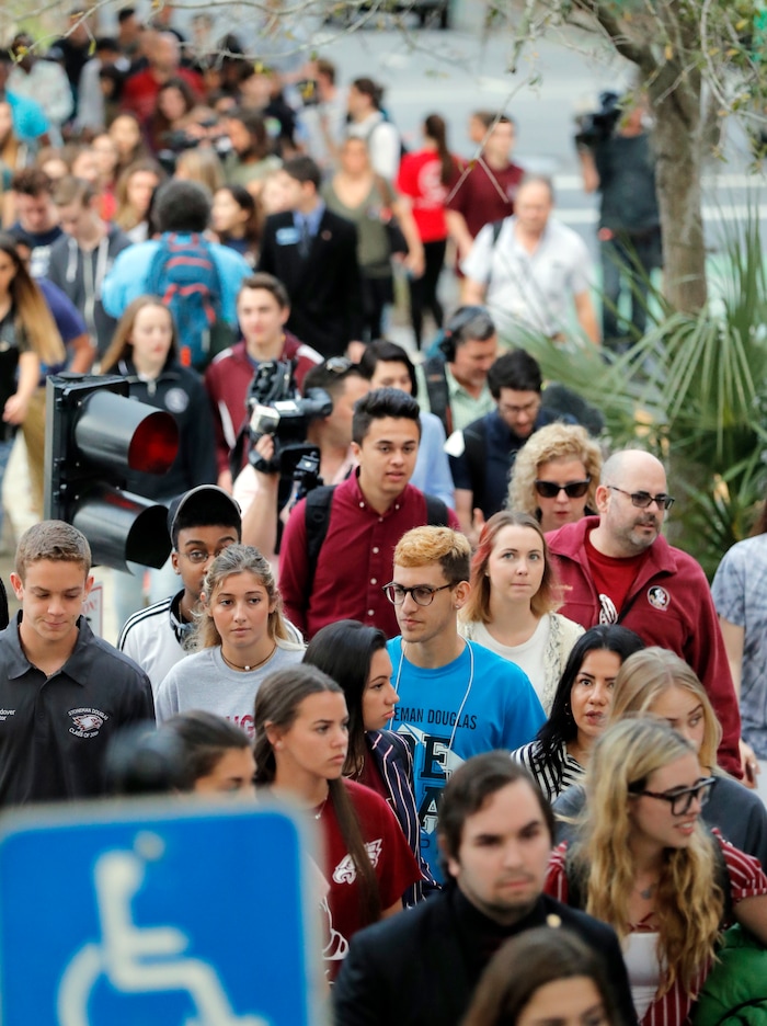 Student survivors from Marjory Stoneman Douglas High School, where over a dozen were killed in a mass shooting on Wednesday, march to the state capitol to challenge legislators on gun control reform, in Tallahassee, Fla., Wednesday, Feb. 21, 2018. (AP Photo/Gerald Herbert)