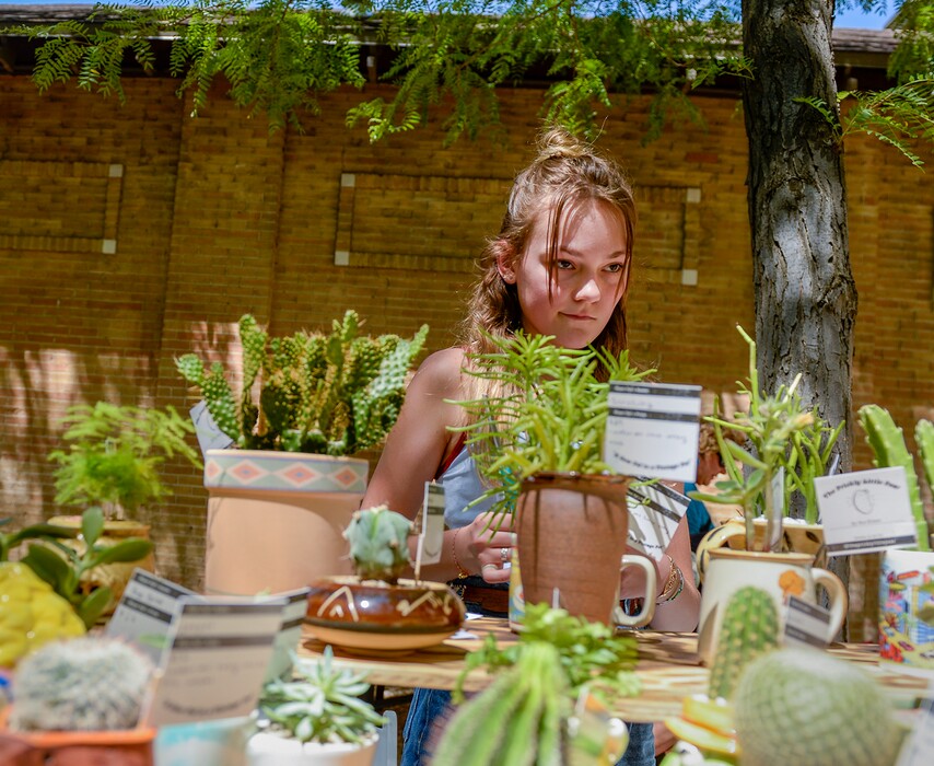 (Leah Hogsten | The Salt Lake Tribune) Ava Brown, 13, from Holladay, sells cactuses and other succulent plants, repotted in vintage ceramic containers at the 2019 Craft Lake City DIY Festival. She was among the sellers on Kid Row, where children 14 and under make and sell their products. Craft Lake City’s 2021 DIY Festival kicks off Friday, August 13 and runs through Sunday, August 15.