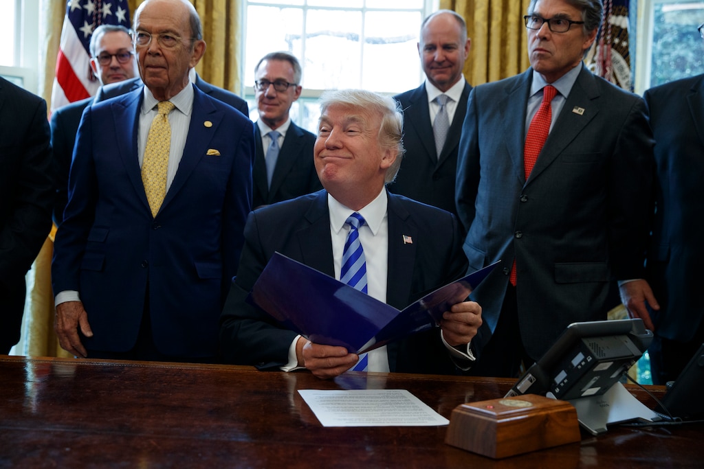 (Evan Vucci | AP file photo) In this March 24, 2017 photo, President Donald Trump, flanked by Commerce Secretary Wilbur Ross, left, and Energy Secretary Rick Perry, is seen in the Oval Office of the White House in Washington, during the announcing of the approval of a permit to build the Keystone XL pipeline.