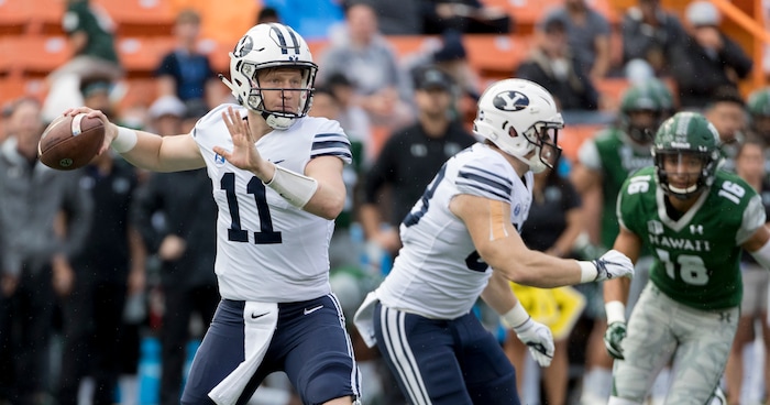BYU quarterback Joe Critchlow (11) throw a pass in the first quarter of an NCAA college football game against Hawaii, Saturday, Nov. 25, 2017, in Honolulu. (AP Photo/Eugene Tanner)